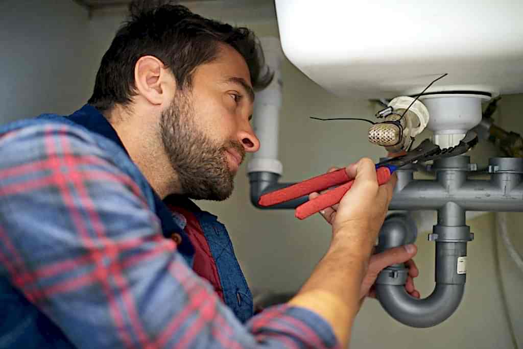 Hes a pro at plumbing. Shot of a plumber fixing a pipe.